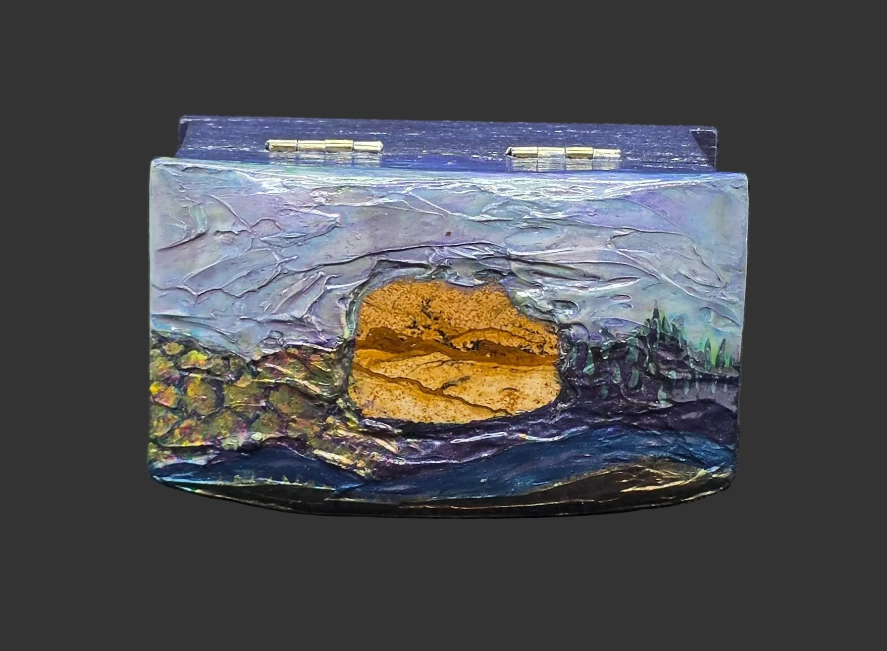 Decorative box with a landscape design extending from picture jasper stone on a textured black background