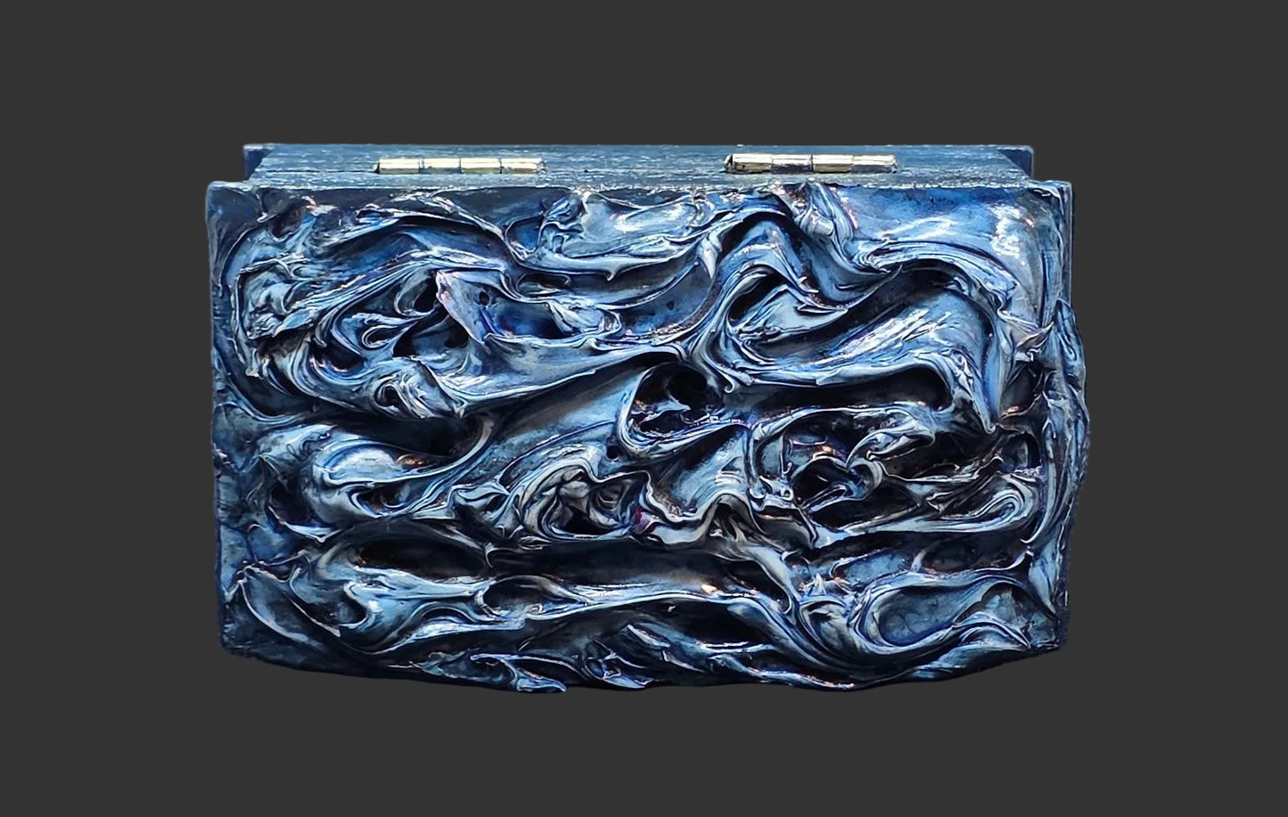 Blue textured painted box on dark background